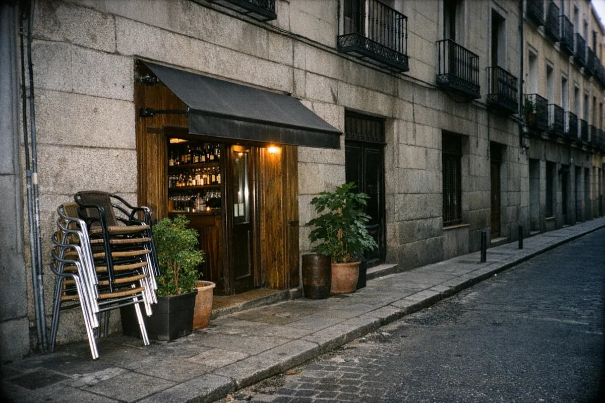 Empty Calle de la Reina storefront and sidewalk outside Angelita in Centro, Madrid.